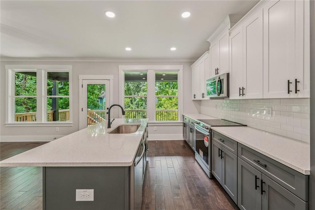 1179 Booker Avenue Southwest Atlanta, GA 30310 - Photo 15 of 54 a kitchen with a stove a sink a refrigerator and a microwave