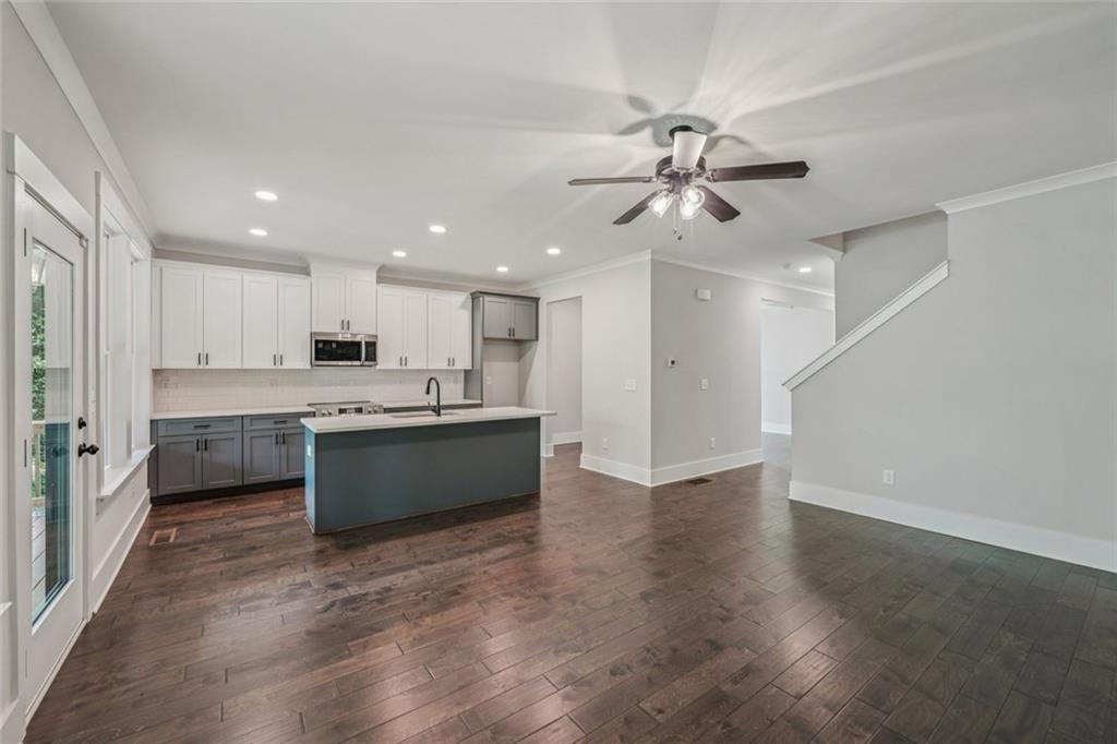 1179 Booker Avenue Southwest Atlanta, GA 30310 - Photo 18 of 54 a large kitchen with a refrigerator a sink dishwasher a stove and a refrigerator with wooden floor