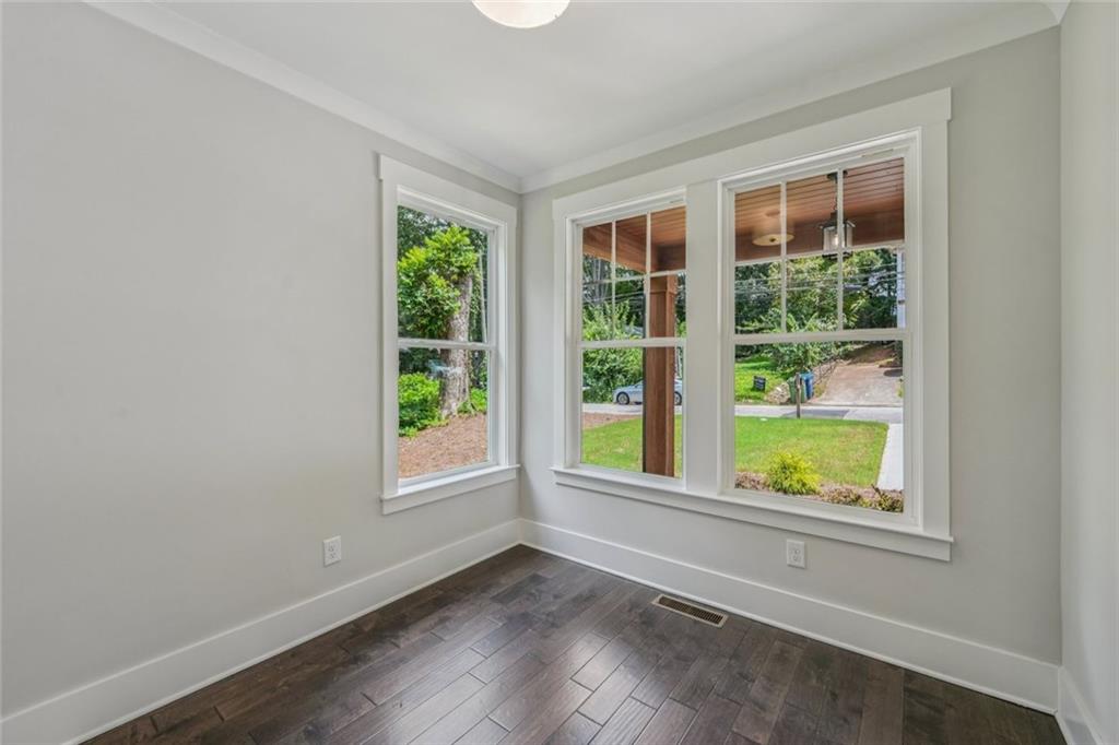 1179 Booker Avenue Southwest Atlanta, GA 30310 - Photo 21 of 54 an empty room with wooden floor and windows