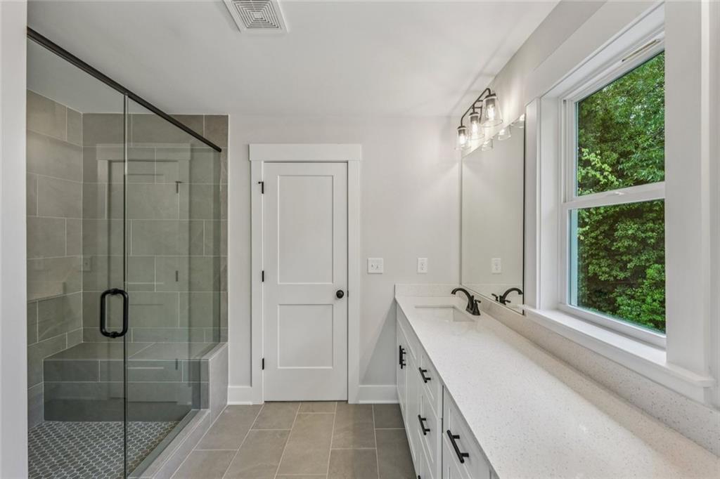 1179 Booker Avenue Southwest Atlanta, GA 30310 - Photo 31 of 54 a bathroom with a double vanity sink and shower