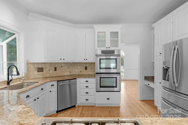 a kitchen with stainless steel appliances a stove sink and cabinets