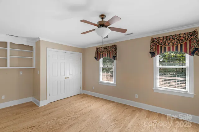 a view of a livingroom with a ceiling fan and window