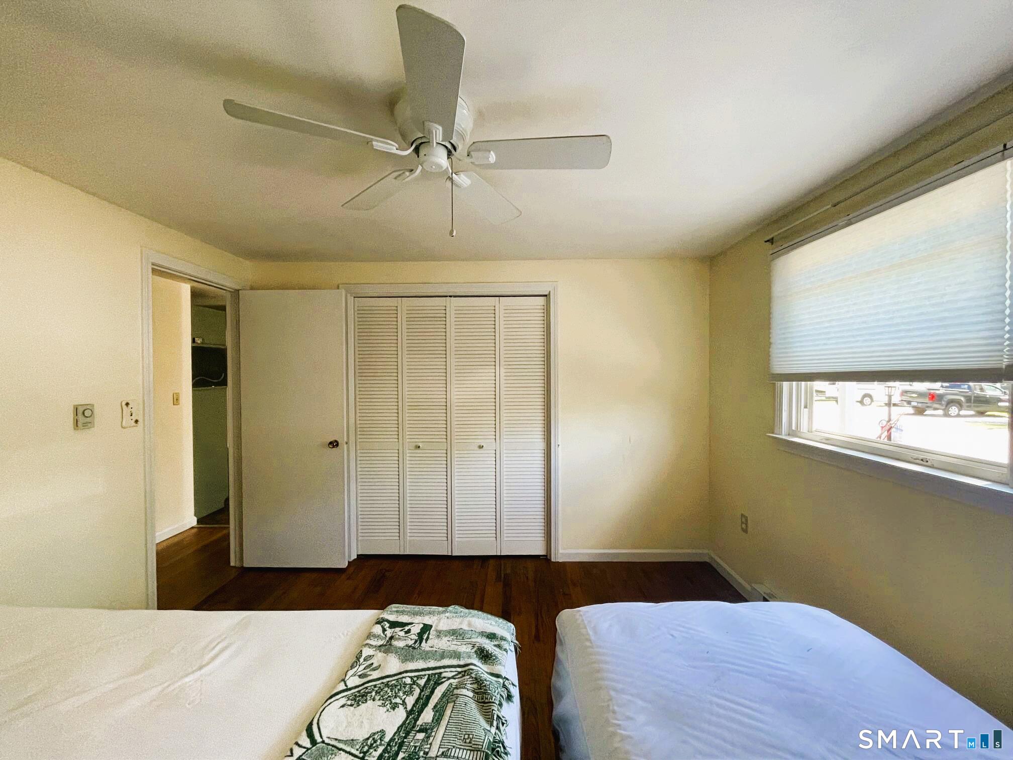18 Old South Cove Road Old Saybrook, CT 06475 - Photo 28 of 40 a bedroom with a bed and a chandelier