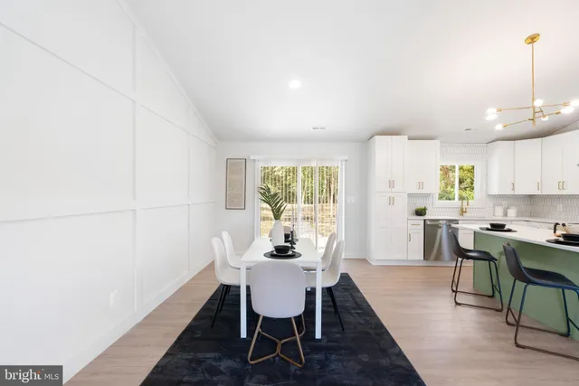 a kitchen that has a sink a stove and cabinets