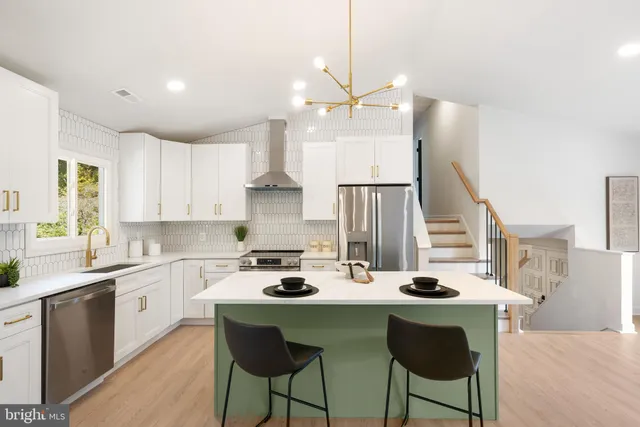 a kitchen with a stove a counter space dining table and chairs