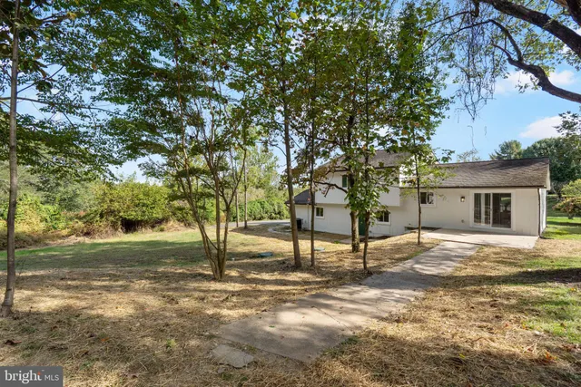 a sign board with a large trees next to it