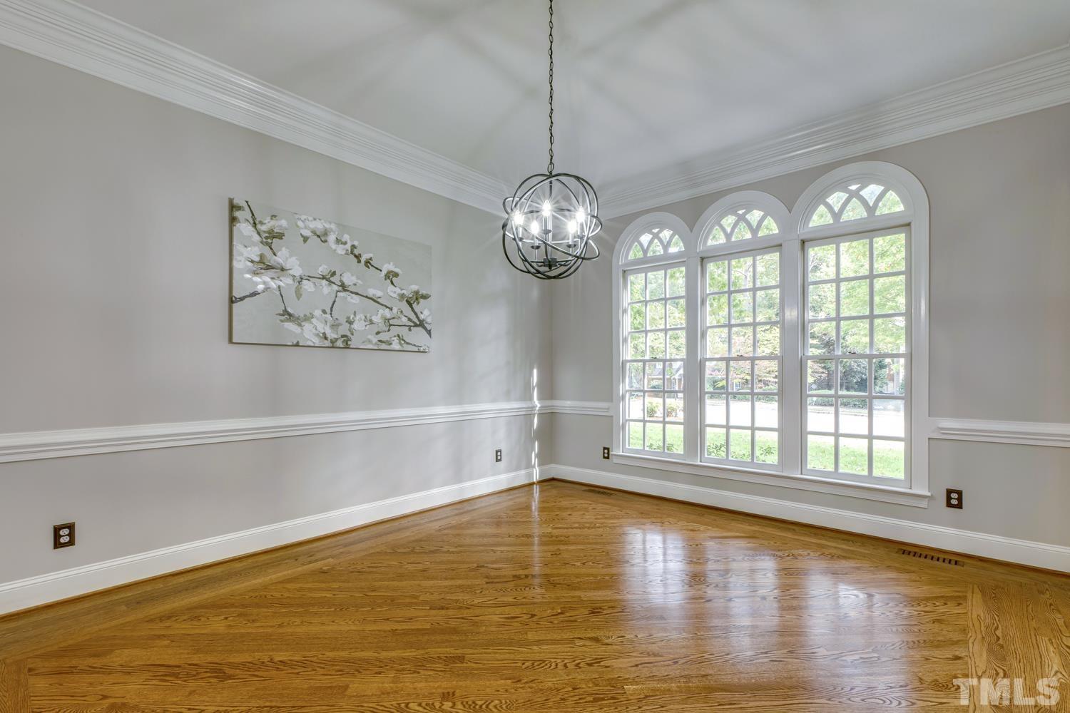 7705 Rainwater Road Raleigh, NC 27615 - Photo 11 of 18 a view of an empty room with wooden floor and a window