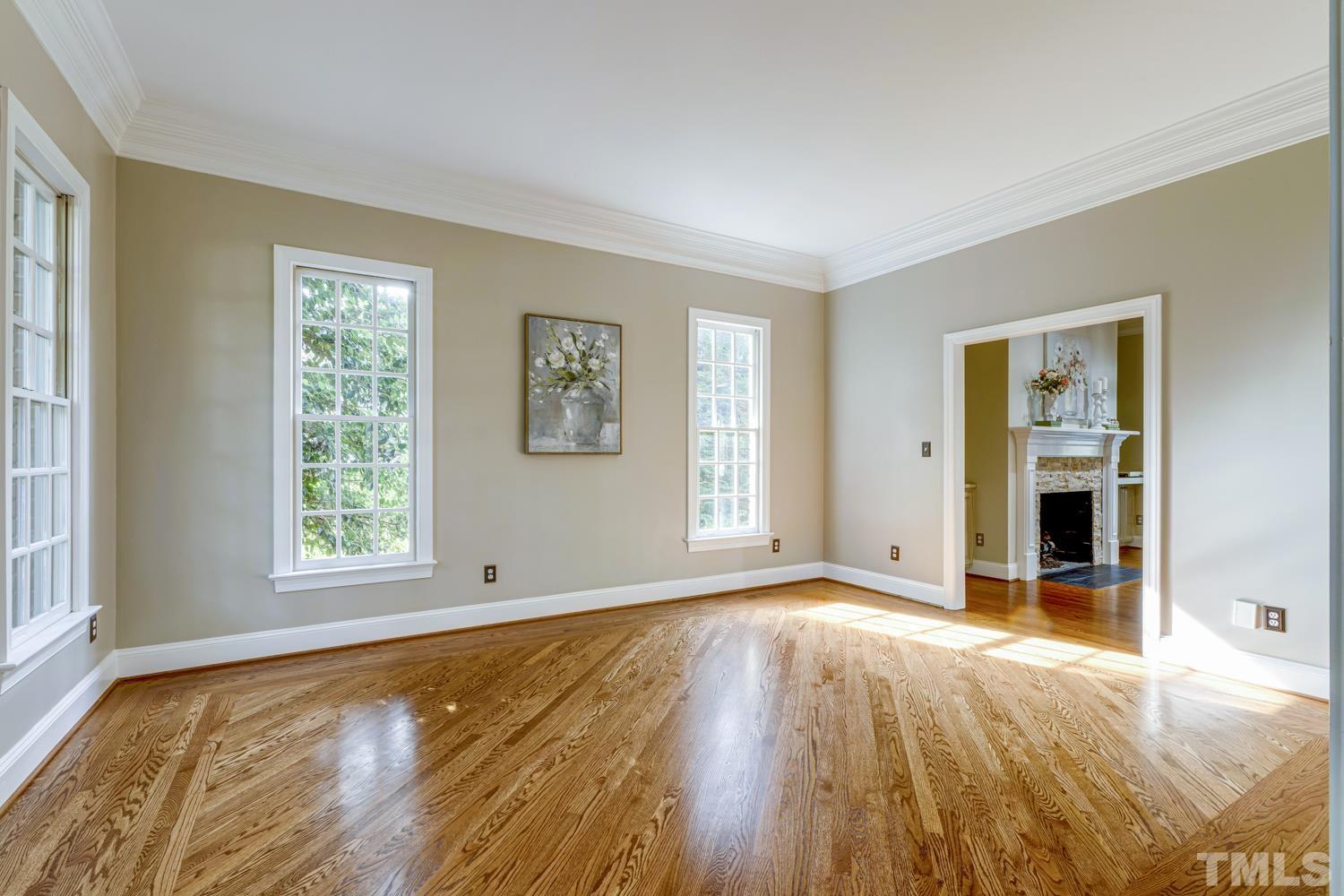 7705 Rainwater Road Raleigh, NC 27615 - Photo 12 of 18 a view of an empty room with wooden floor and a window