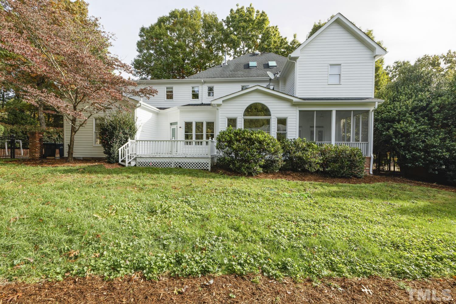 7705 Rainwater Road Raleigh, NC 27615 - Photo 14 of 18 a view of a white house with garden and plants