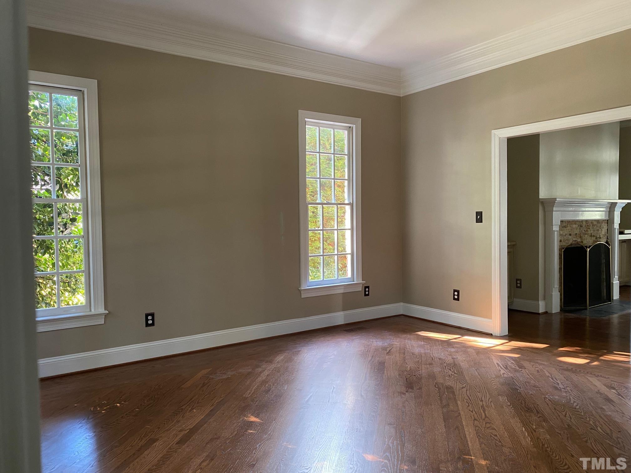 7705 Rainwater Road Raleigh, NC 27615 - Photo 1 of 18 an empty room with wooden floor and windows