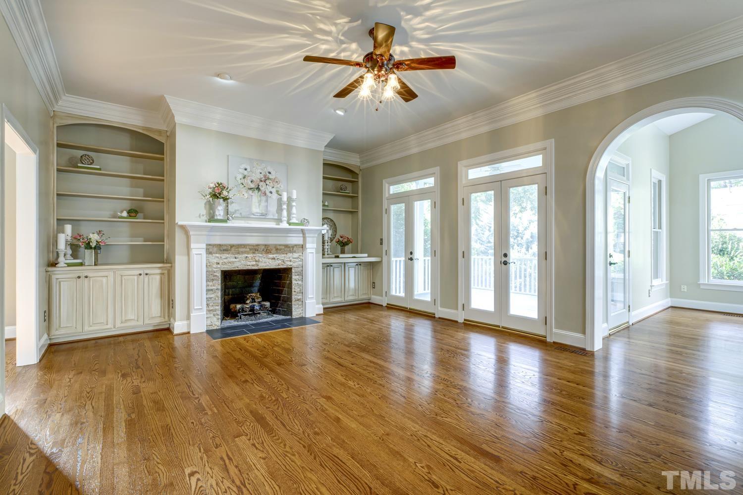 7705 Rainwater Road Raleigh, NC 27615 - Photo 3 of 18 a view of an empty room with a fireplace and a window