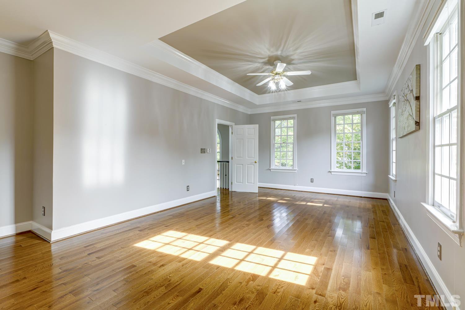 7705 Rainwater Road Raleigh, NC 27615 - Photo 5 of 18 wooden floor in an empty room with a window