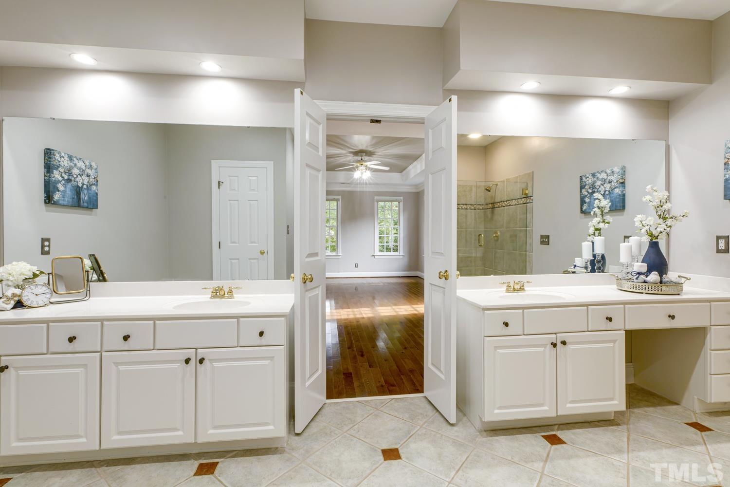 7705 Rainwater Road Raleigh, NC 27615 - Photo 6 of 18 a spacious bathroom with a granite countertop sink and a mirror