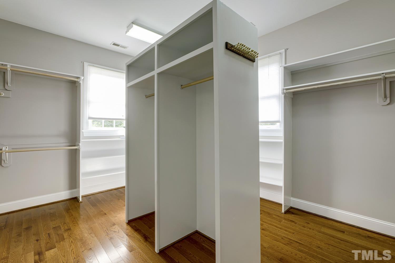 7705 Rainwater Road Raleigh, NC 27615 - Photo 8 of 18 a view of walk in closet with wooden floor