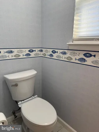 a white toilet sitting next to a window