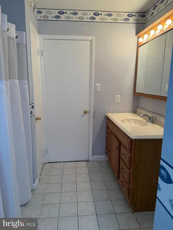 a bathroom with a sink a mirror and shower