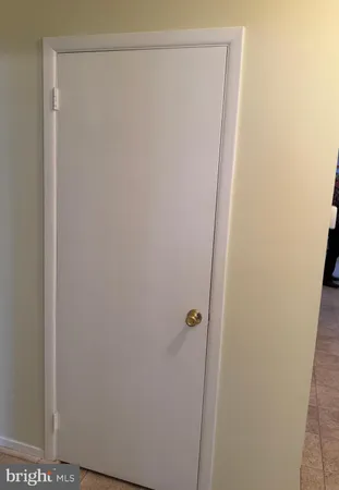 a bedroom with a bed and a mirror