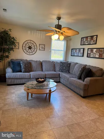 a living room with furniture a clock and a window