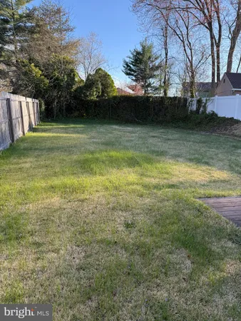 a view of house with a backyard