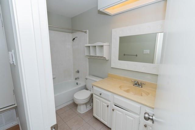 106 Mapleleaf Lane Coppell, TX 75019 - Photo 30 of 36 Bathroom featuring a white vanity with a tan countertop, an integrated sink, and white cabinetry