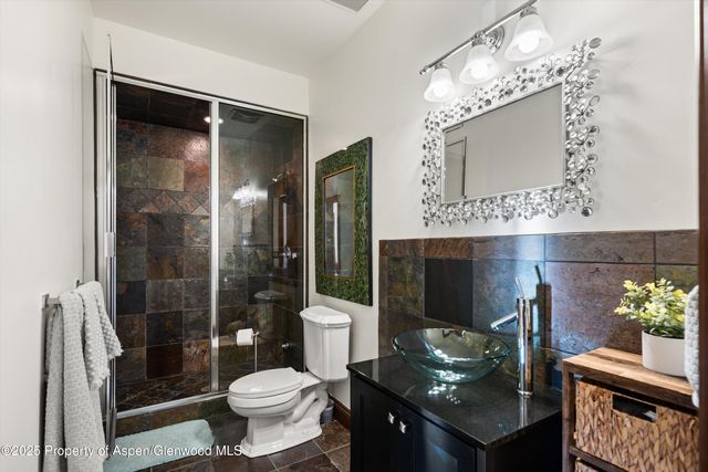 a bathroom with a toilet sink and shower