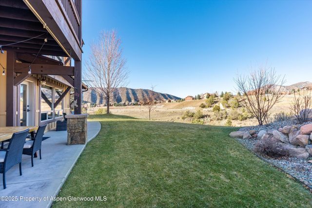 a view of a house with backyard porch and furniture