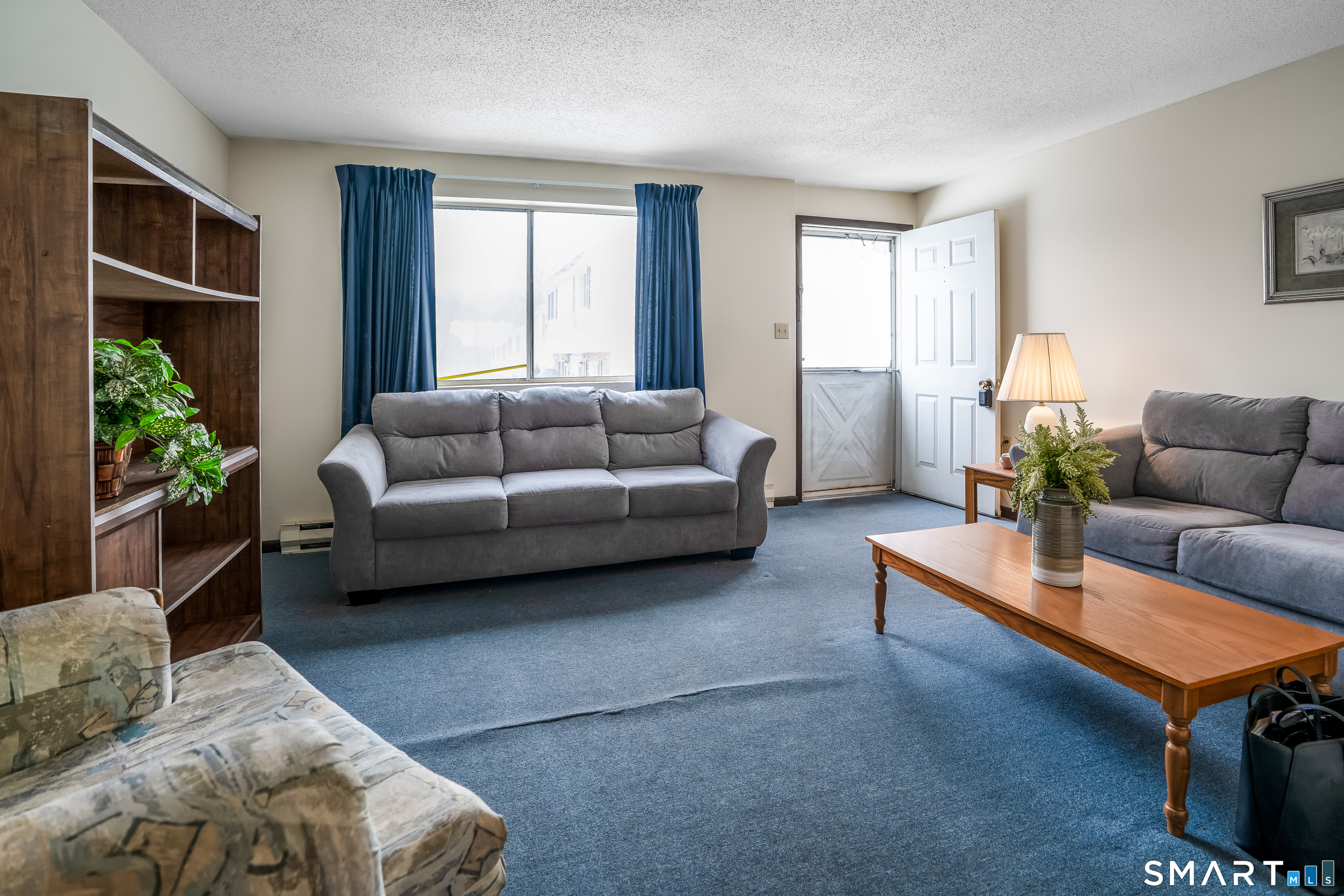 461 Spring Street, Unit 3B Naugatuck, CT 06770 - Photo 13 of 13 a living room with furniture and a large window