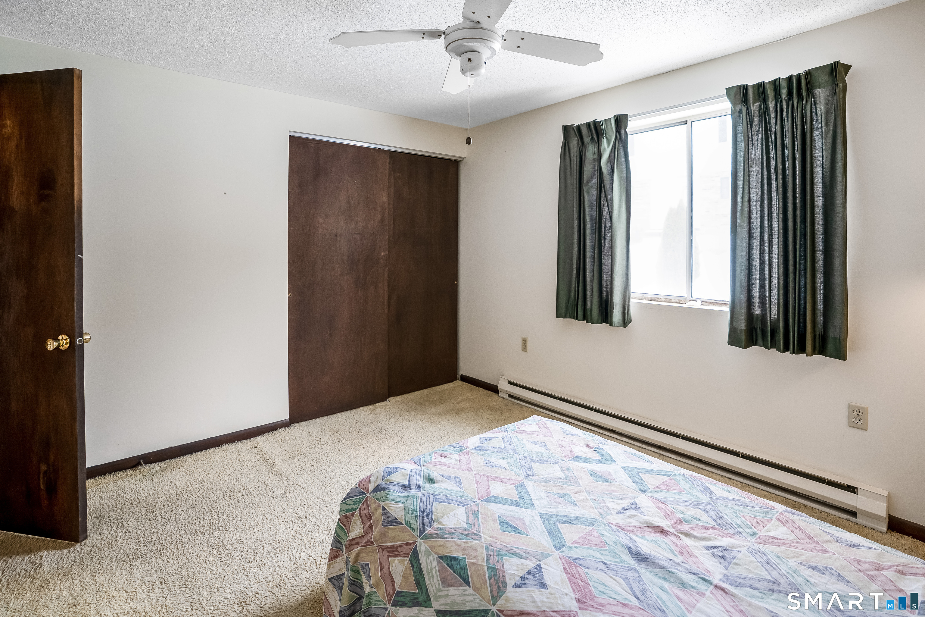 461 Spring Street, Unit 3B Naugatuck, CT 06770 - Photo 4 of 13 a view of a livingroom with wooden floor and a ceiling fan