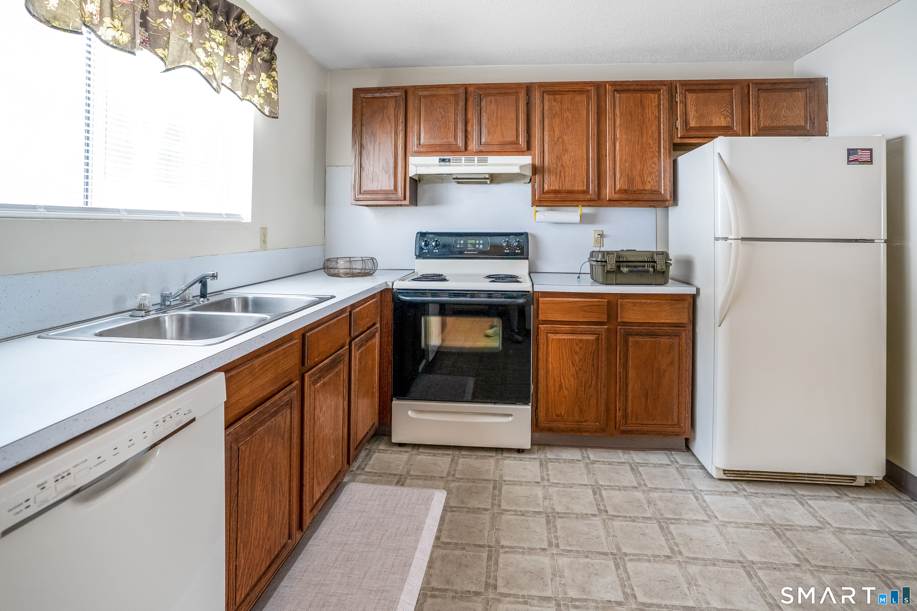 461 Spring Street, Unit 3B Naugatuck, CT 06770 - Photo 7 of 13 a kitchen with stainless steel appliances granite countertop a stove a sink and a refrigerator