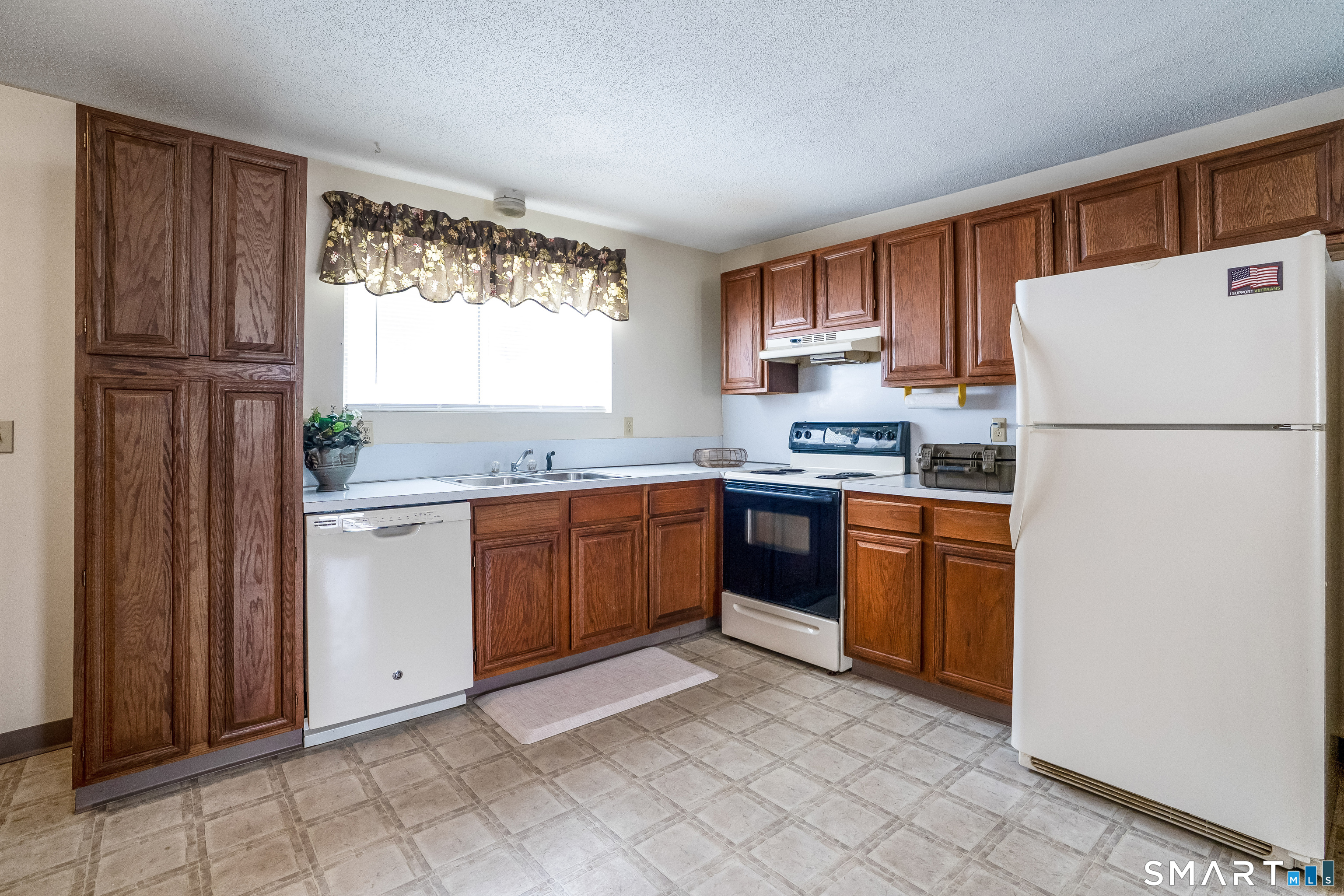 461 Spring Street, Unit 3B Naugatuck, CT 06770 - Photo 8 of 13 a kitchen with granite countertop a refrigerator sink stove and cabinets
