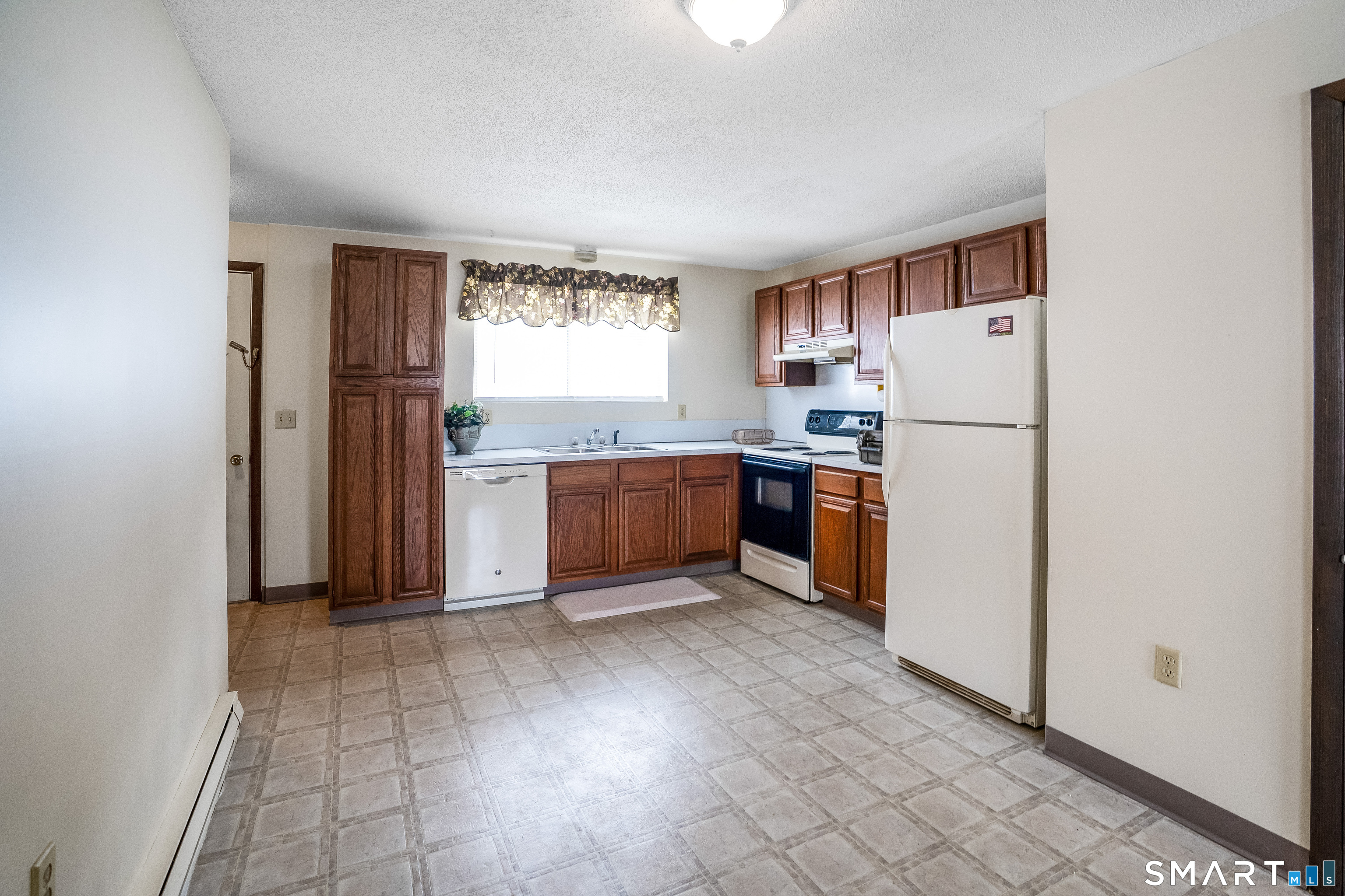 461 Spring Street, Unit 3B Naugatuck, CT 06770 - Photo 9 of 13 a kitchen with stainless steel appliances a refrigerator sink and cabinets
