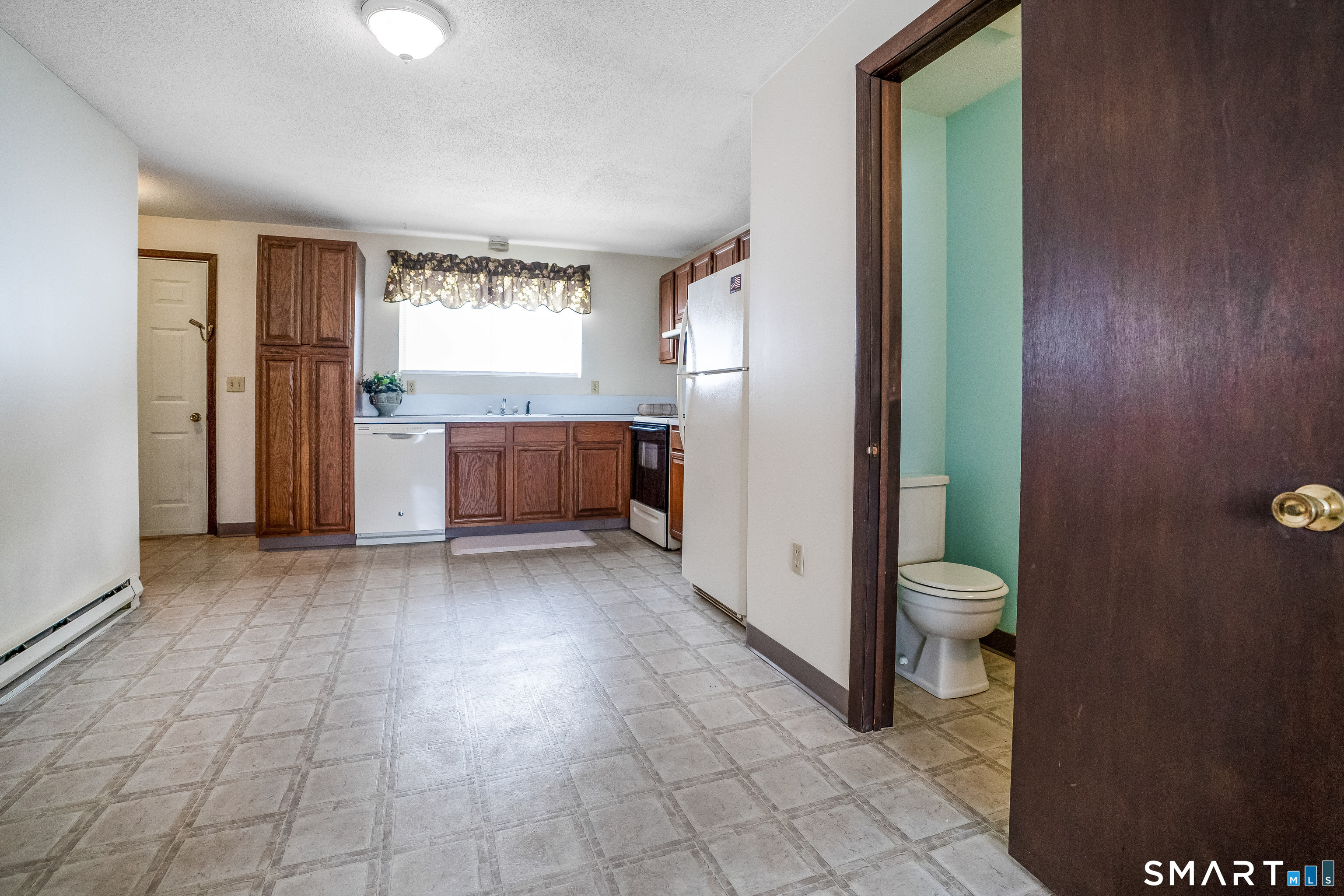 461 Spring Street, Unit 3B Naugatuck, CT 06770 - Photo 10 of 13 a view of a kitchen with refrigerator and window