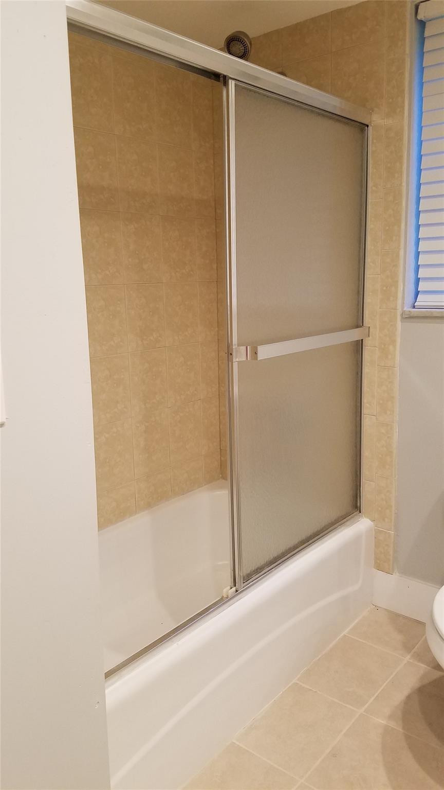 3100 North Course Lane, Unit 210 Pompano Beach, FL 33069 - Photo 11 of 28 a bathroom with a glass shower door