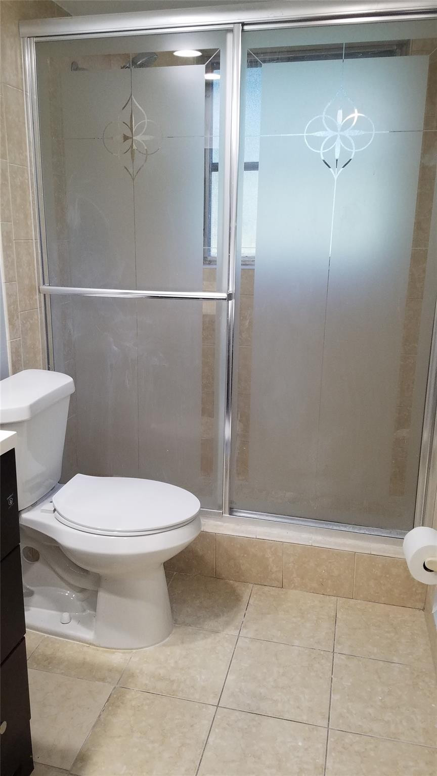 3100 North Course Lane, Unit 210 Pompano Beach, FL 33069 - Photo 16 of 28 a bathroom with a toilet and a shower