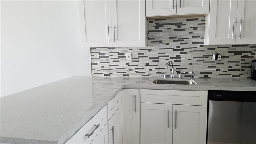 3100 North Course Lane, Unit 210 Pompano Beach, FL 33069 - Photo 2 of 28 a kitchen with cabinets