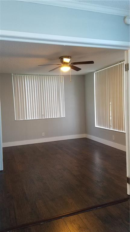 3100 North Course Lane, Unit 210 Pompano Beach, FL 33069 - Photo 21 of 28 a view of an empty room with wooden floor and a window