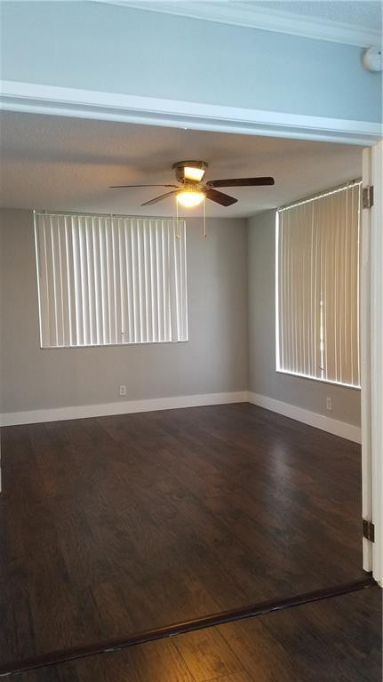 3100 North Course Lane, Unit 210 Pompano Beach, FL 33069 - Photo 24 of 28 a view of an empty room with wooden floor and a window