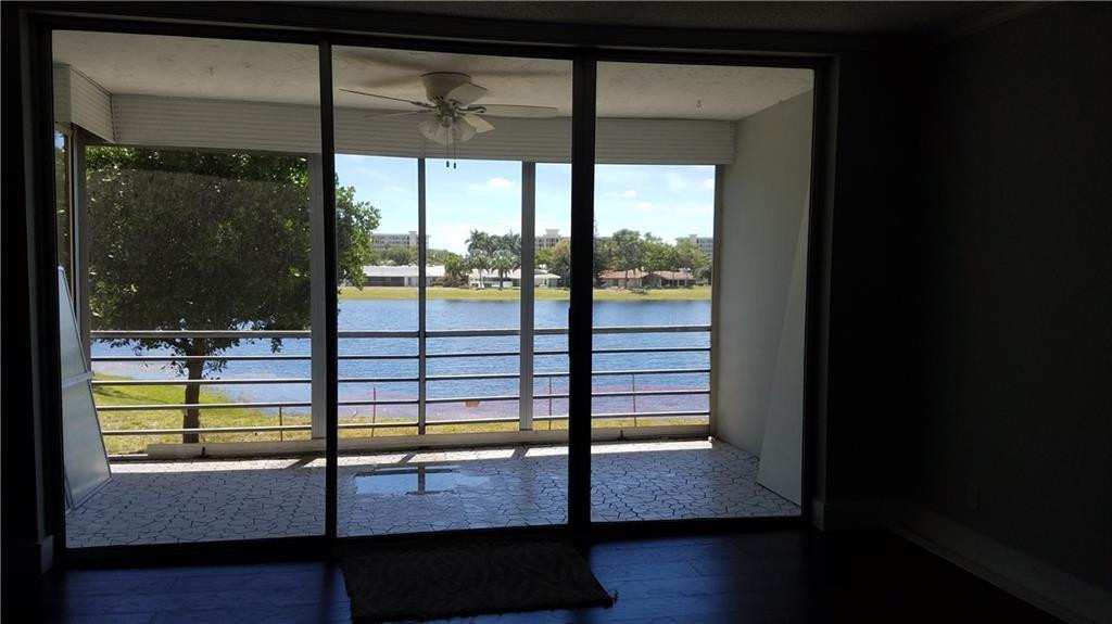 3100 North Course Lane, Unit 210 Pompano Beach, FL 33069 - Photo 26 of 28 a view of empty room with wooden floor and fan