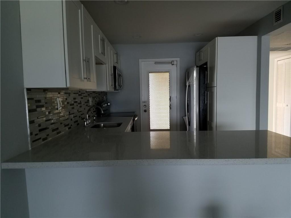 3100 North Course Lane, Unit 210 Pompano Beach, FL 33069 - Photo 3 of 28 a view of a furniture in an empty room