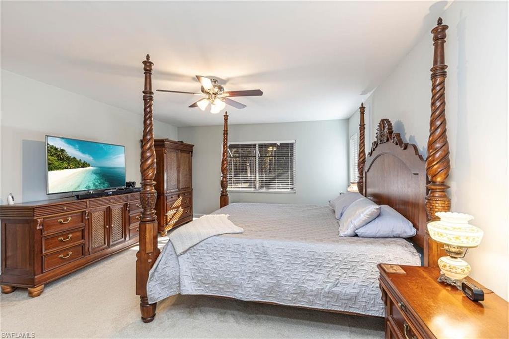 960 21st Street Southwest Naples, FL 34117 - Photo 15 of 33 a bedroom with a bed and a flat tv screen on dresser
