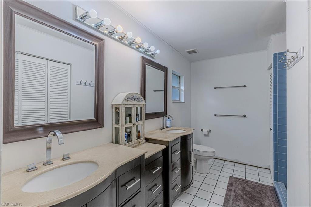 960 21st Street Southwest Naples, FL 34117 - Photo 16 of 33 a bathroom with a sink double vanity and a mirror