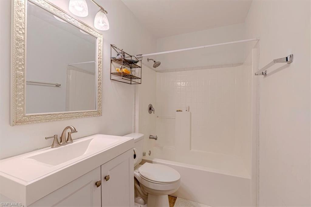 960 21st Street Southwest Naples, FL 34117 - Photo 19 of 33 a bathroom with a sink toilet vanity and shower