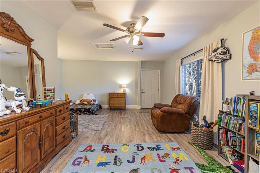 960 21st Street Southwest Naples, FL 34117 - Photo 21 of 33 a bedroom with furniture a baby crib and a window
