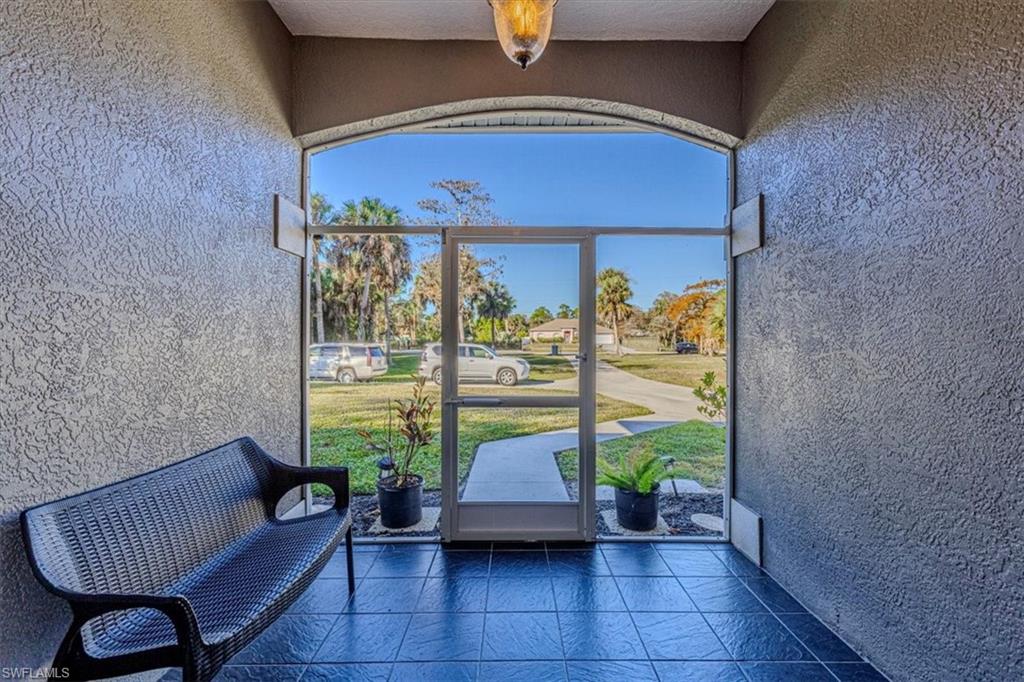 960 21st Street Southwest Naples, FL 34117 - Photo 27 of 33 a living room with furniture and a potted plant