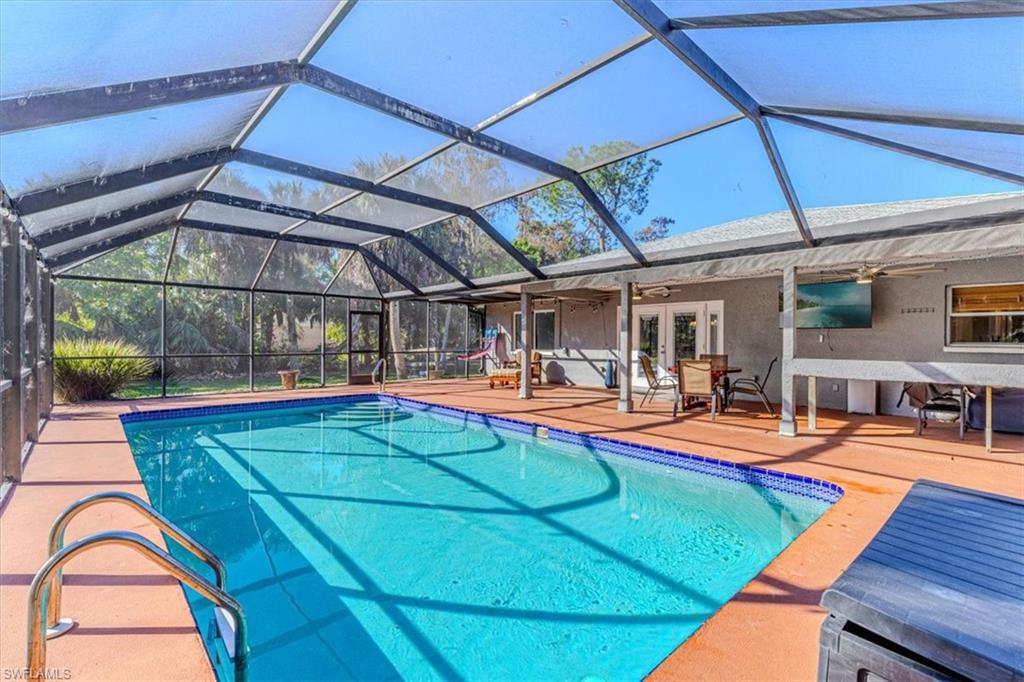 960 21st Street Southwest Naples, FL 34117 - Photo 31 of 33 a view of a swimming pool with an outdoor seating