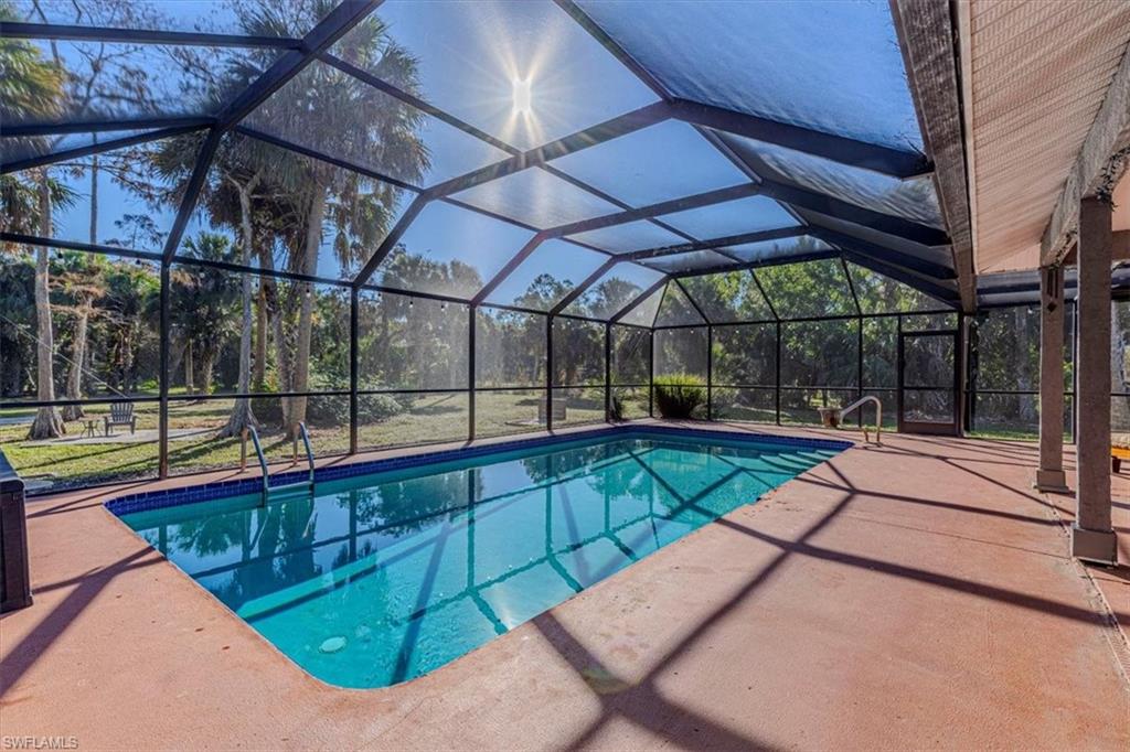 960 21st Street Southwest Naples, FL 34117 - Photo 32 of 33 a view of a swimming pool with a porch