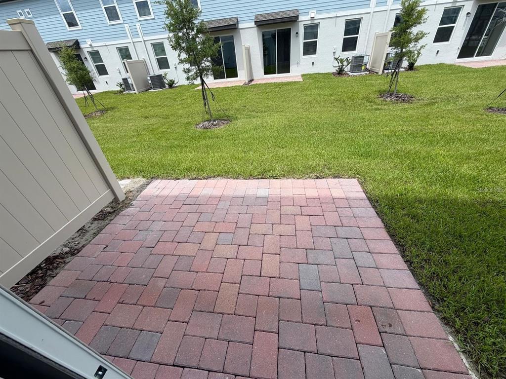4256 Ranch House Road St. Cloud, FL 34772 - Photo 25 of 30 a front view of a house with a garden