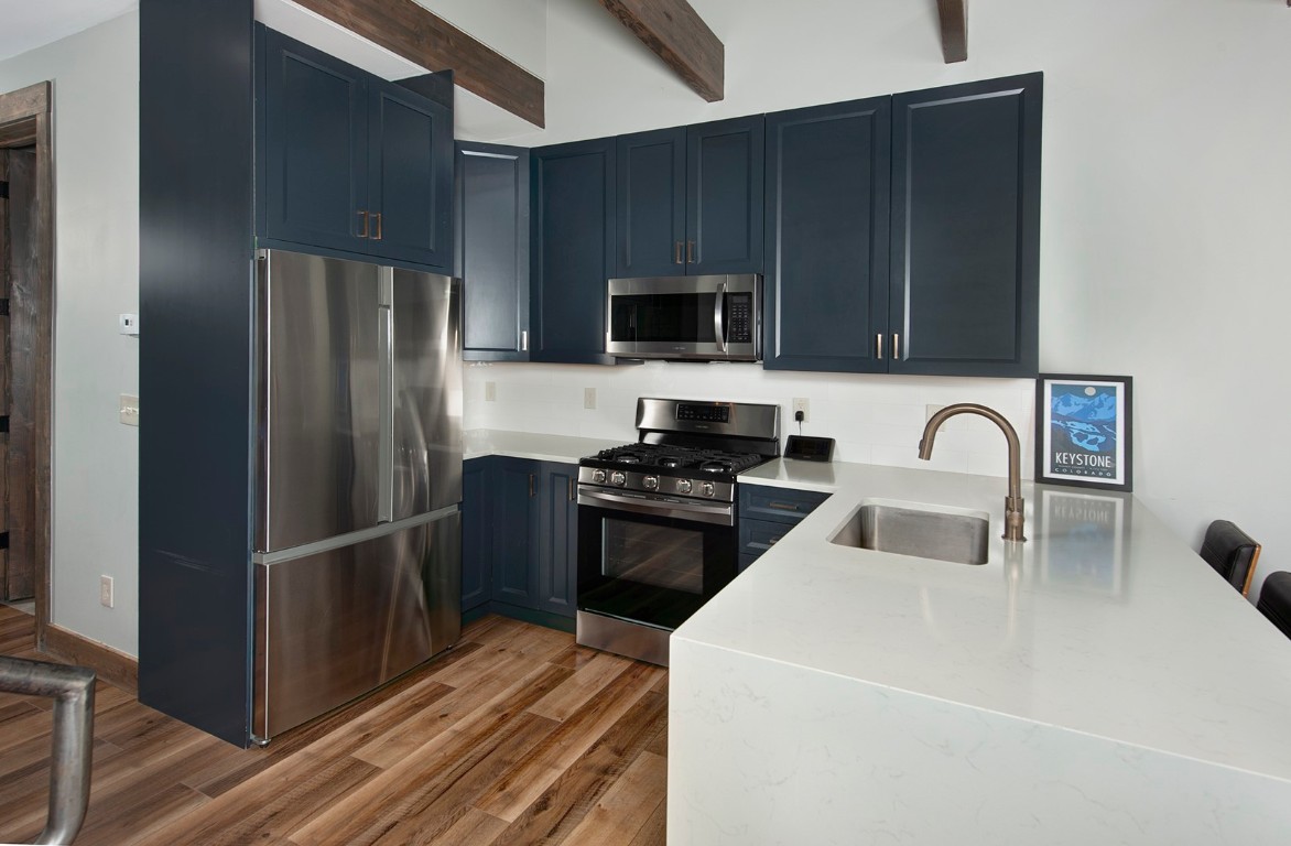 102 Lake Ridge Circle, Unit 1891 Keystone, CO 80435 - Photo 13 of 34 a kitchen with stainless steel appliances a refrigerator stove and microwave