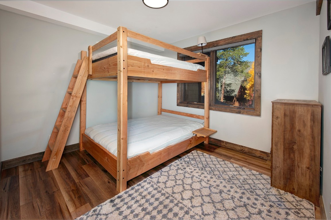 102 Lake Ridge Circle, Unit 1891 Keystone, CO 80435 - Photo 19 of 34 a view of a hallway with wooden floor and furniture