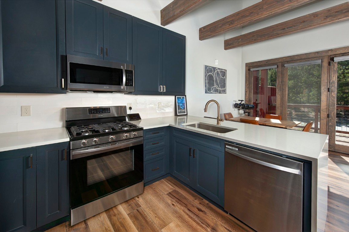 102 Lake Ridge Circle, Unit 1891 Keystone, CO 80435 - Photo 2 of 34 a kitchen with stainless steel appliances a stove a sink and a microwave